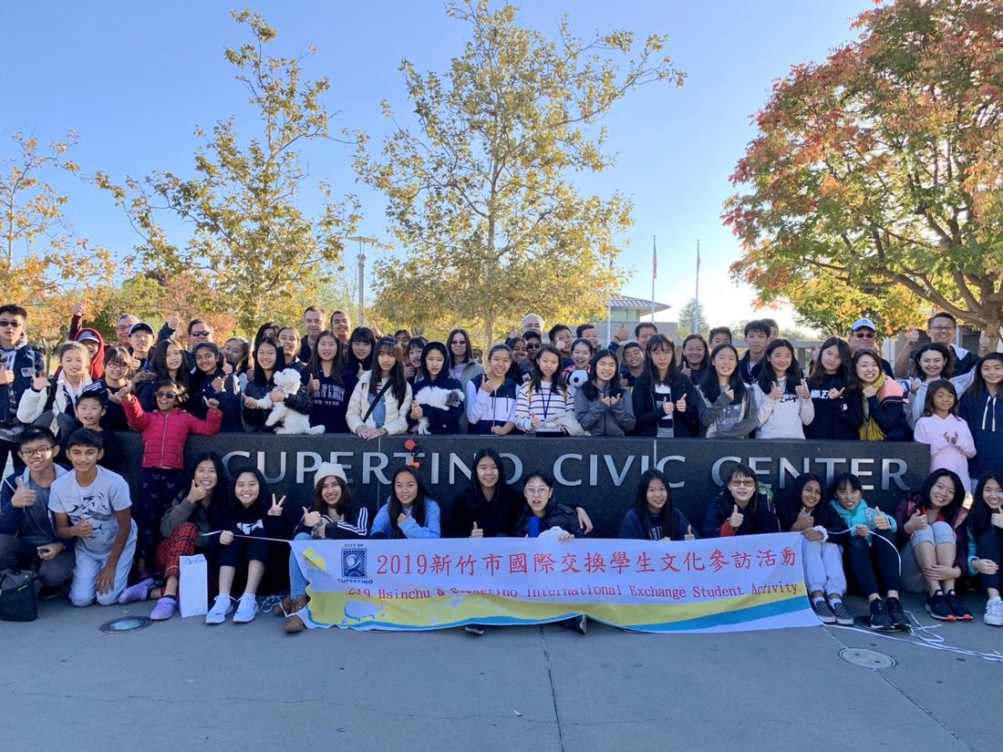The whole exchange group at the Cupertino Civic Center with the banner
